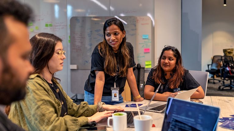 Stephanie Kaiser, senior designer; Rashida Kanchwala, senior software engineer; and Ankita Katiyar, software engineer, all from QuantumBlack, collaborated with Iguazio team members at a recent GenAI hackathon.