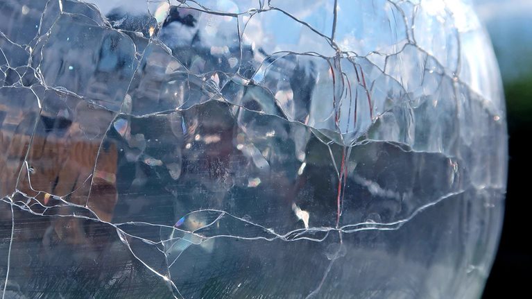 Cracked glass vase. Refracted, reflected and distorted light. Abstract background