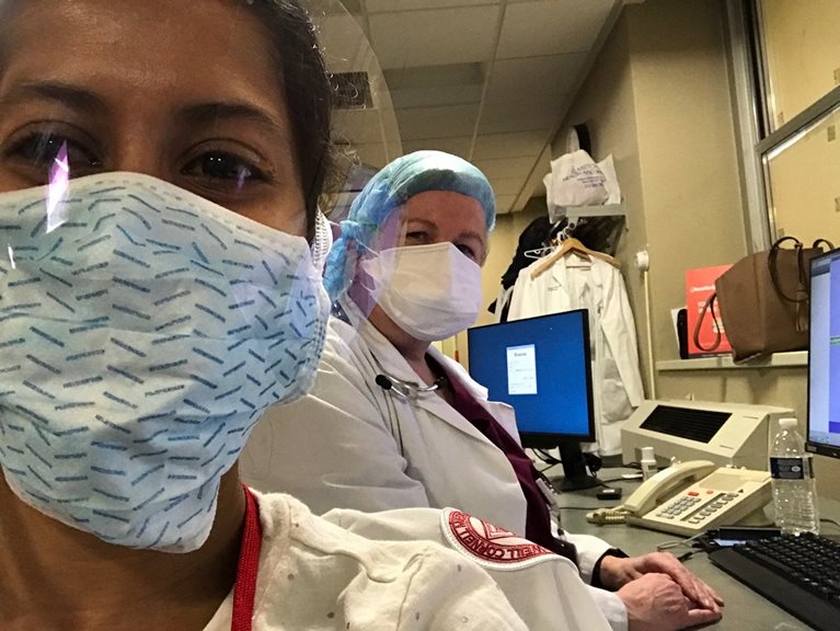 Ashita and colleague wearing medical uniforms and mask