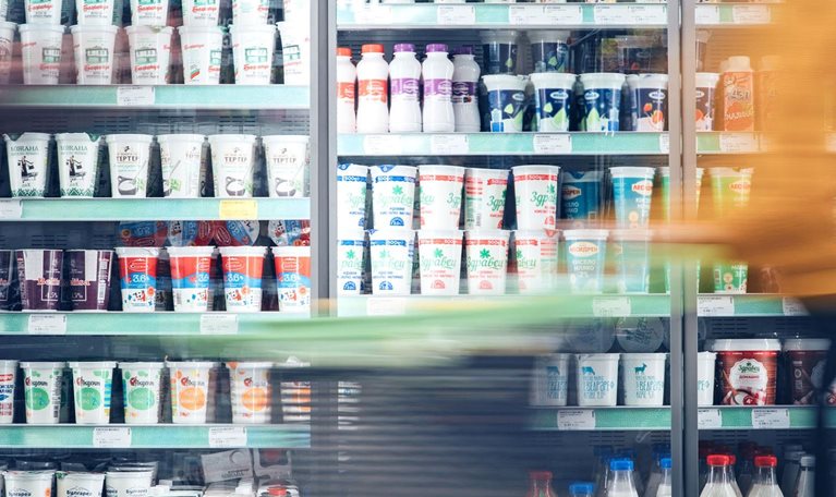 Blurred motion of energetic people on the move while shopping in a grocery store.