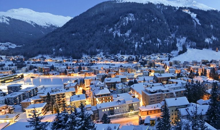 Snow-covered city at the foot of mountains