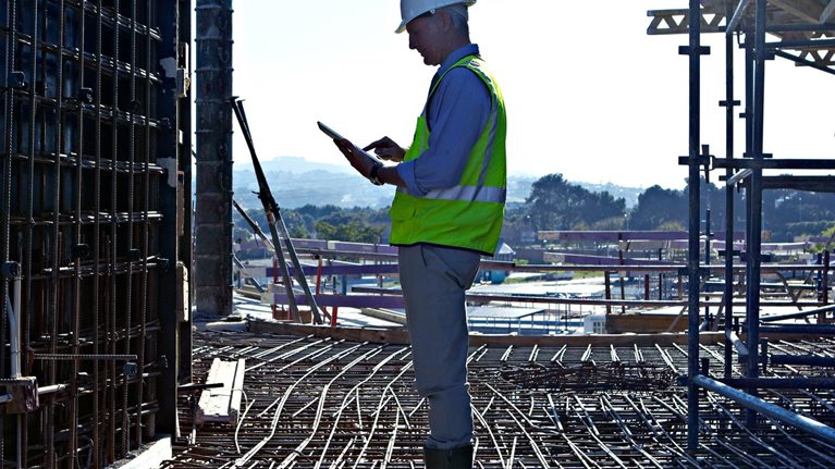 Worker man standing at a construction site
