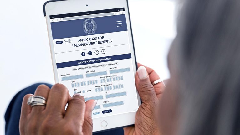 Woman filling out unemployment benefits form on her tablet