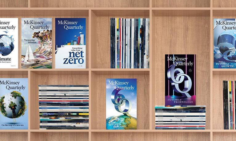 Book shelf featuring past issues of the McKinsey Quarterly birthday editions magazines