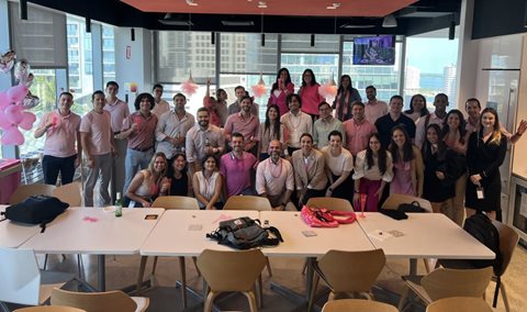 Jorge Amar (bottom center) celebrates Day of Pink 2024 with Miami office colleagues 