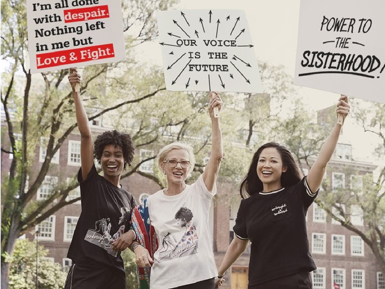 Image of Lisa Sun and two others holding signs