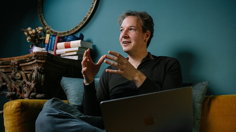 Felix Oldenburg seated on couch