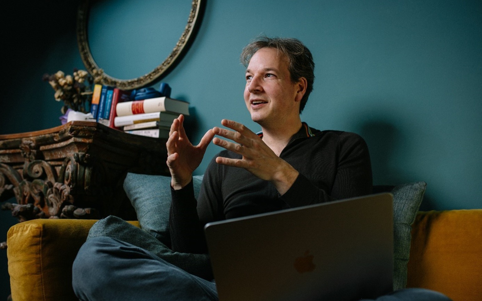 Felix Oldenburg seated on couch