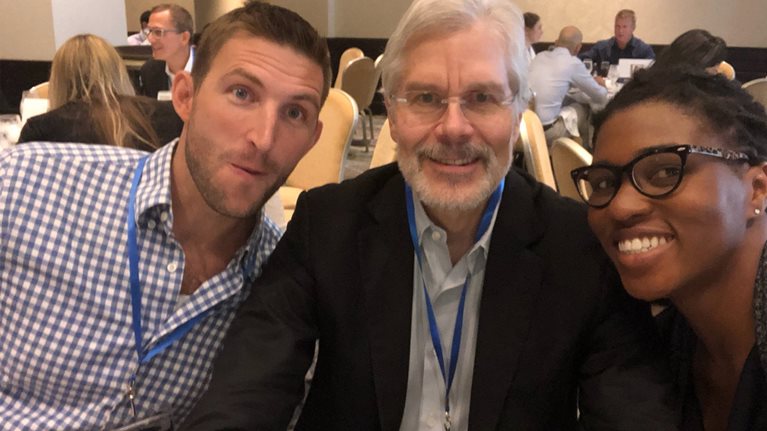 Luke Owings and Taiwo Ajayi sit on either side of Peter Olson