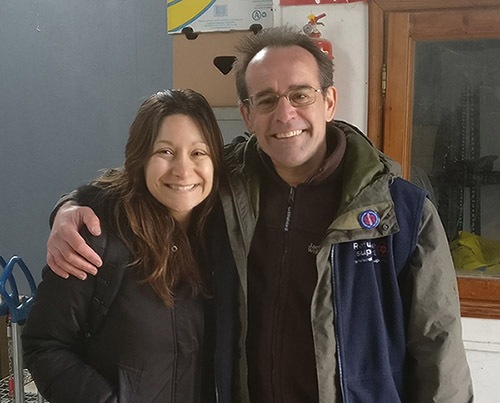 Dina Nayeri with a refugee camp worker