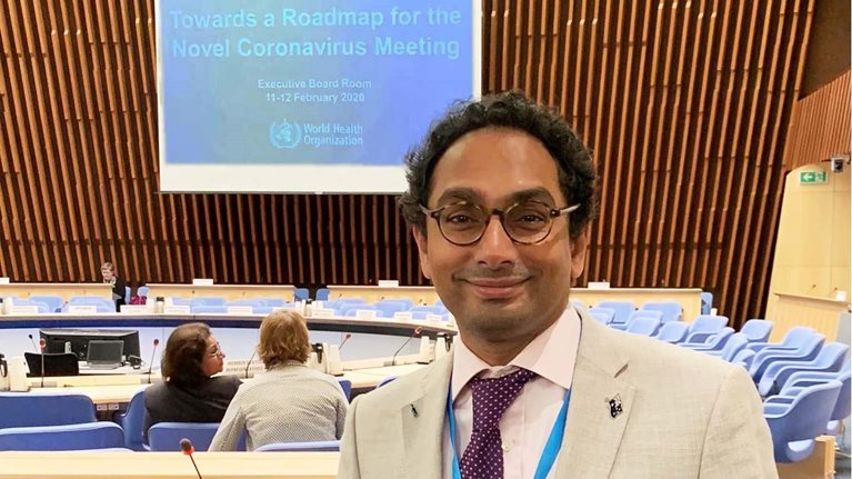 Vas Vasan standing in a conference room