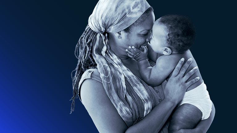 A side view of a mother holding her child