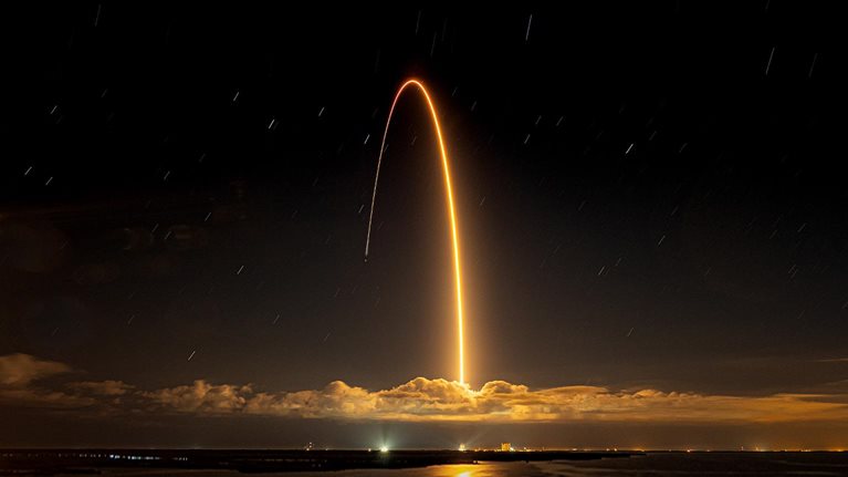 Beautiful shot of a rocket launched against a dark night sky - stock photo