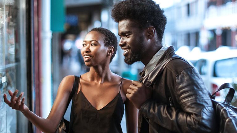 African couple window shopping