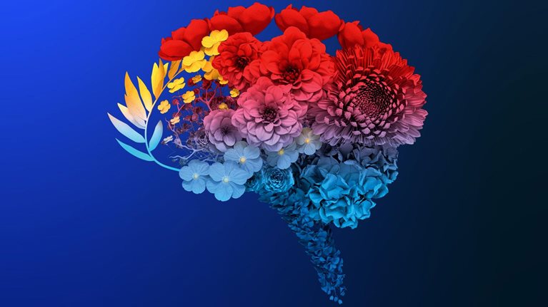 Various flowers, each distinct in kind and color, form the intricate silhouette of a human brain. Above it, a delicate butterfly prepares to land upon this blossoming formation.