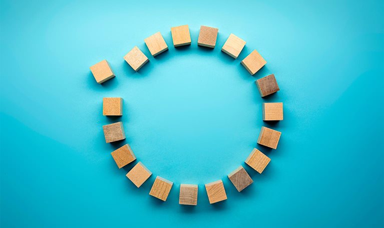 Wooden blocks in a circle on a blue background