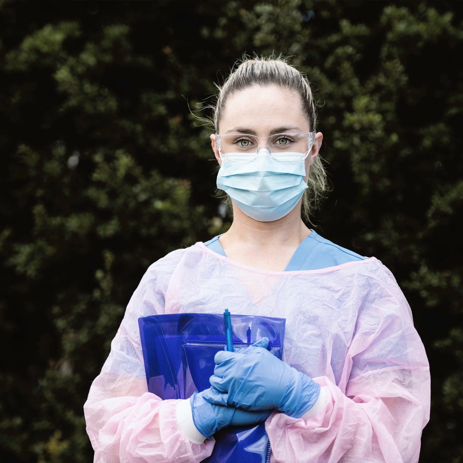 Portrait of Nurse Wearing Protective Workwear Outdoors - stock photo