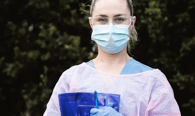 Portrait of Nurse Wearing Protective Workwear Outdoors - stock photo