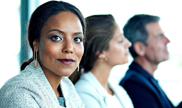 Female black corporate professional stares at camera