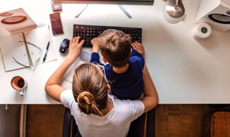 Young mother working from home - stock photo