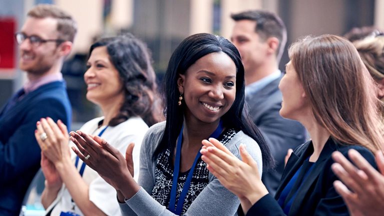Audience Applauding Speaker After Conference Presentation