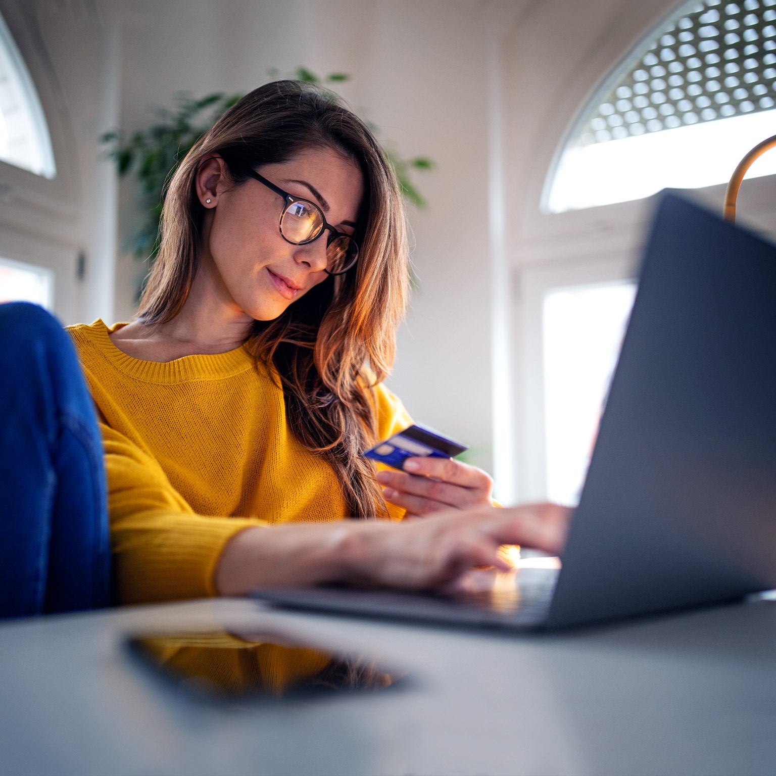 A young woman shopping online paying with credit card