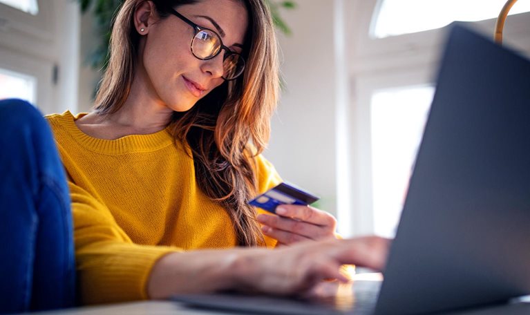 A young woman shopping online paying with credit card