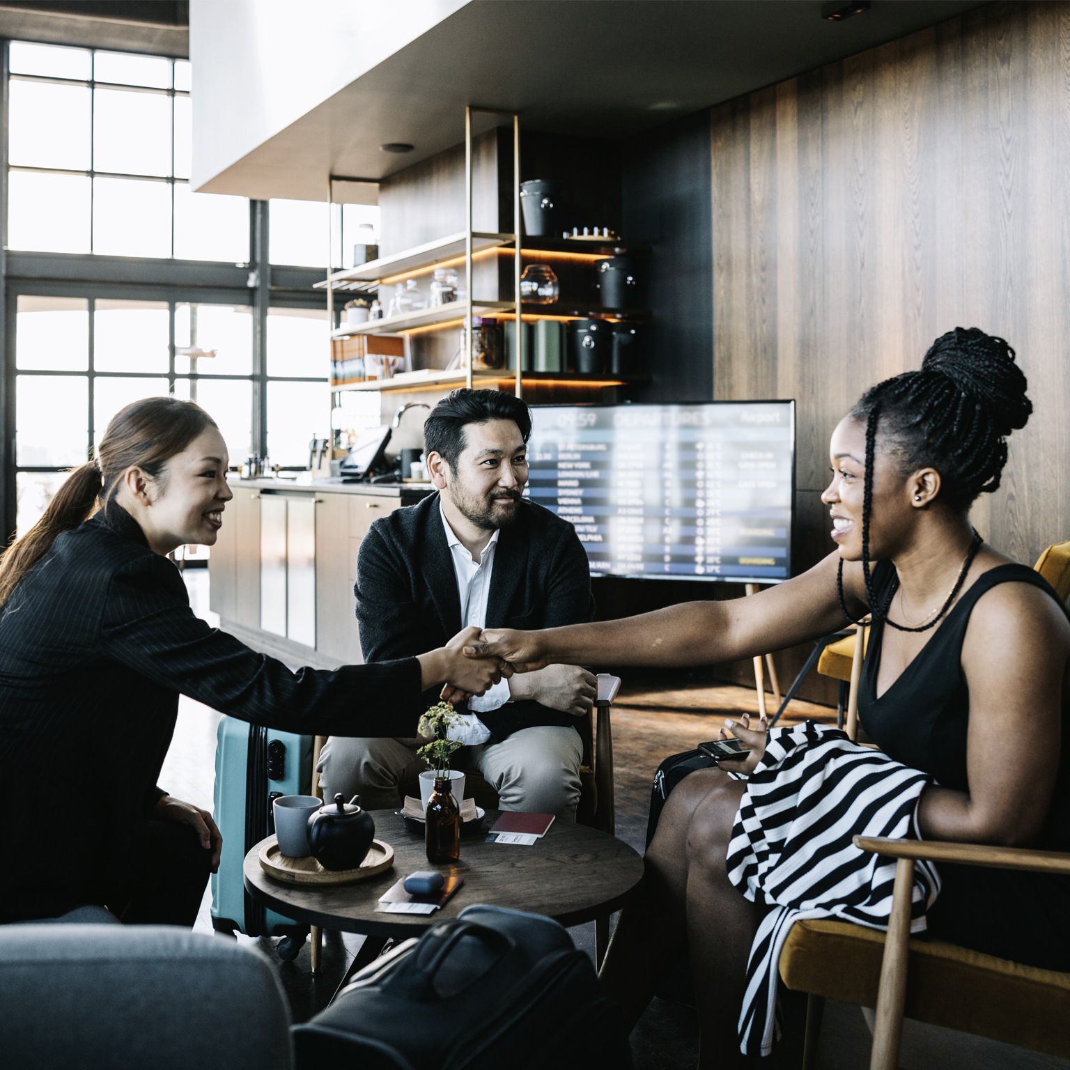 Three people greeting each other