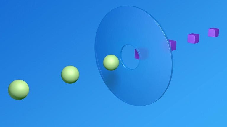 A 3D render of 3 spheres and 4 cubes meeting in the middle. A clear disc with a hole in the middle bridges the two sides.