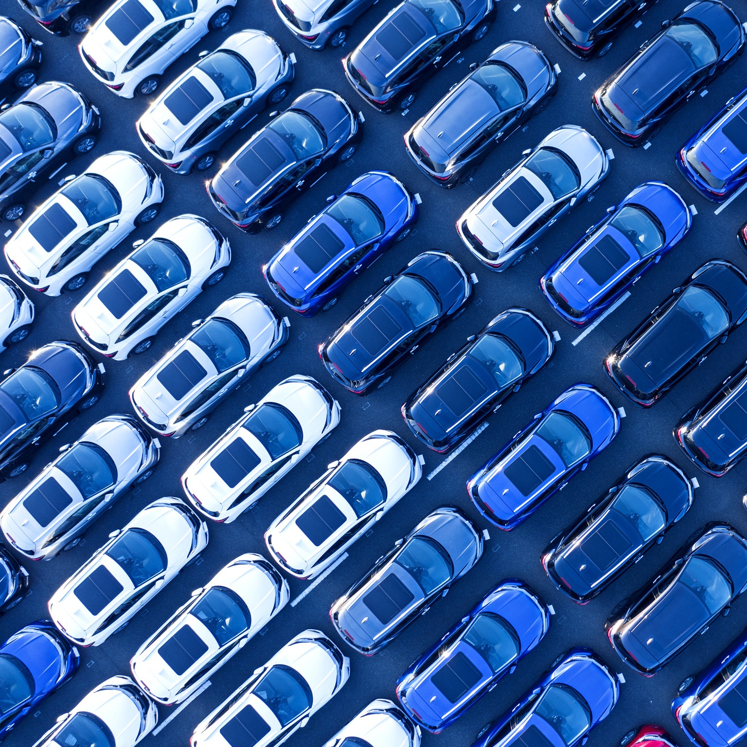 Aerial view of cars parked in many rows