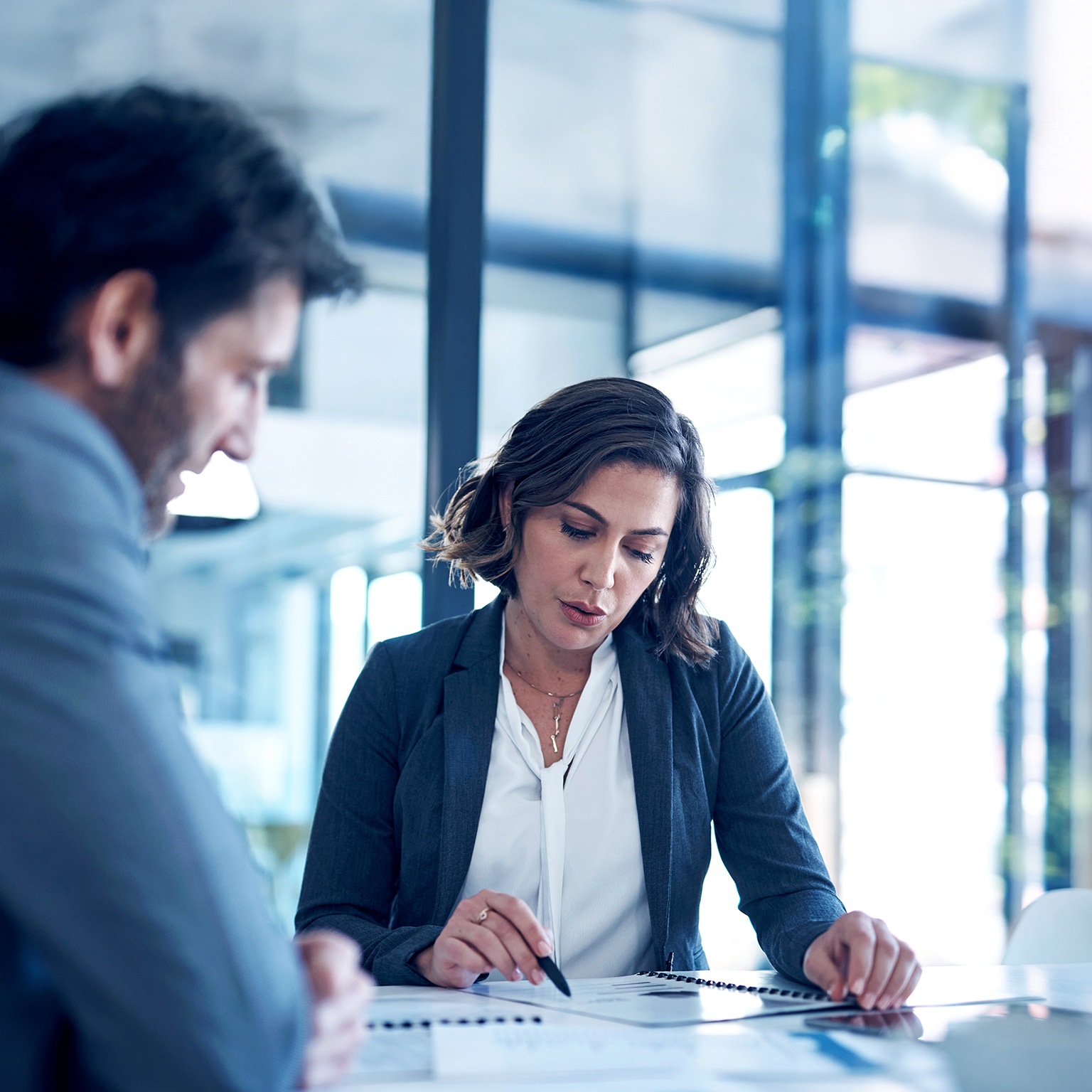 A businessman and businesswoman reviewing paperwork in the office