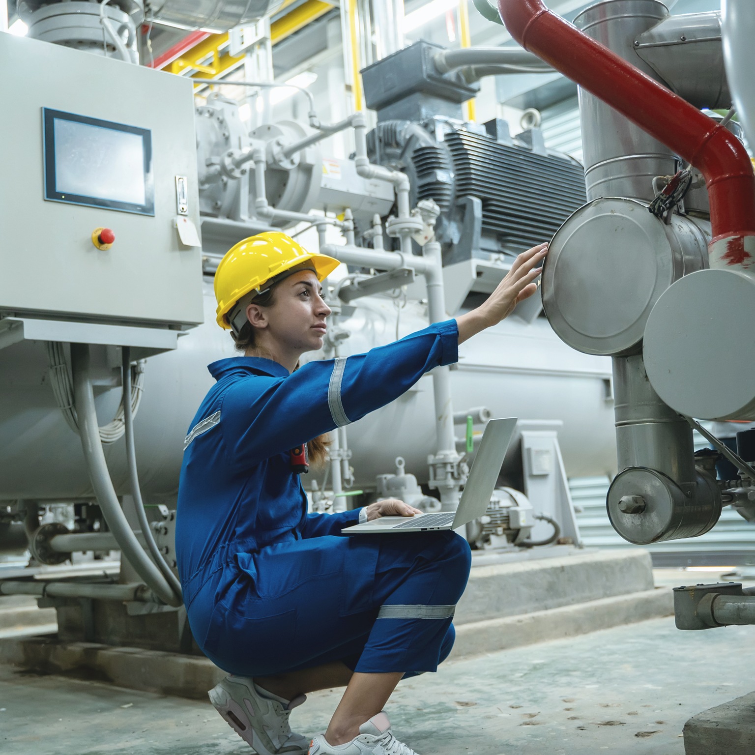 Electrical engineer woman working in an industrial boiler control room