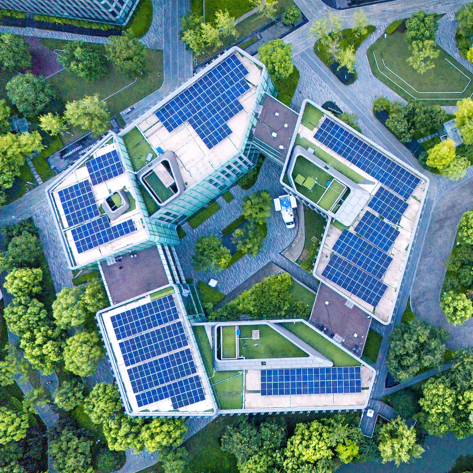Solar panels on city rooftops at dusk