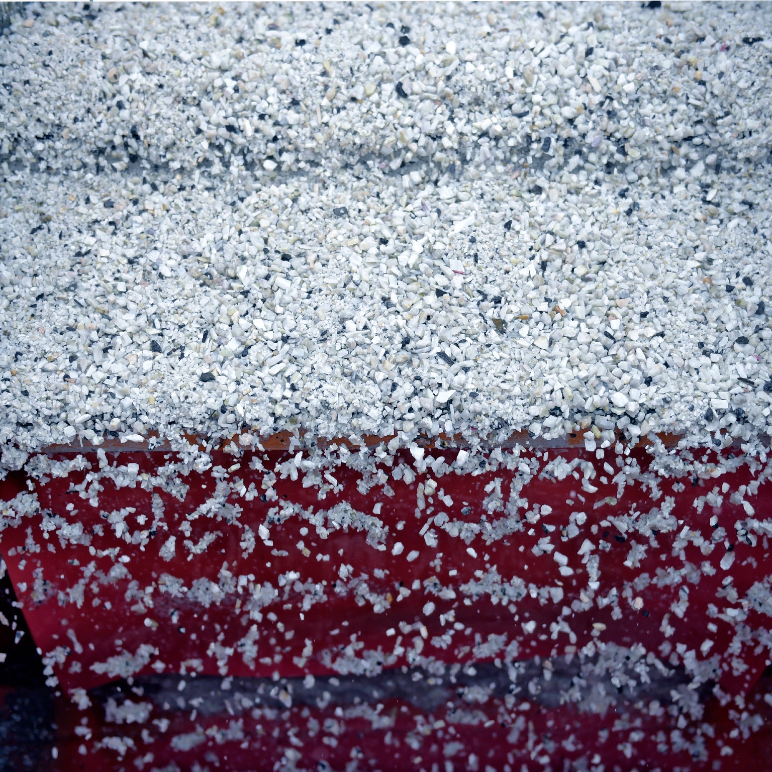 Lithium ore falls through a separation machine