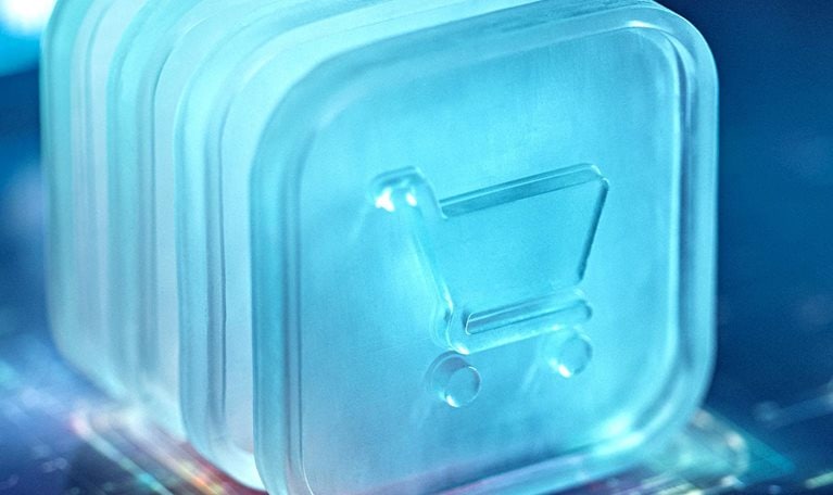 A digital shopping cart icon is illuminated in a futuristic blue light, symbolizing technology and e-commerce advancements