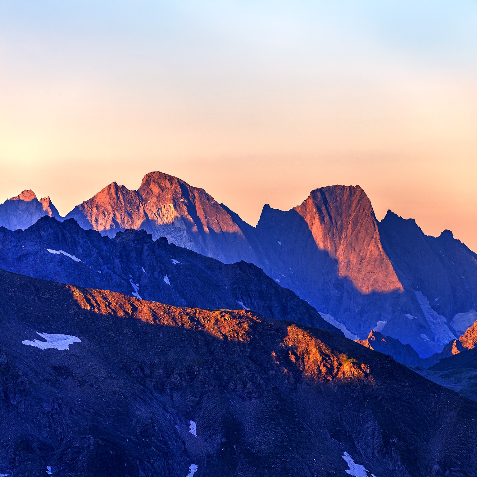 An image of a majestic mountain ridge-line at first light.