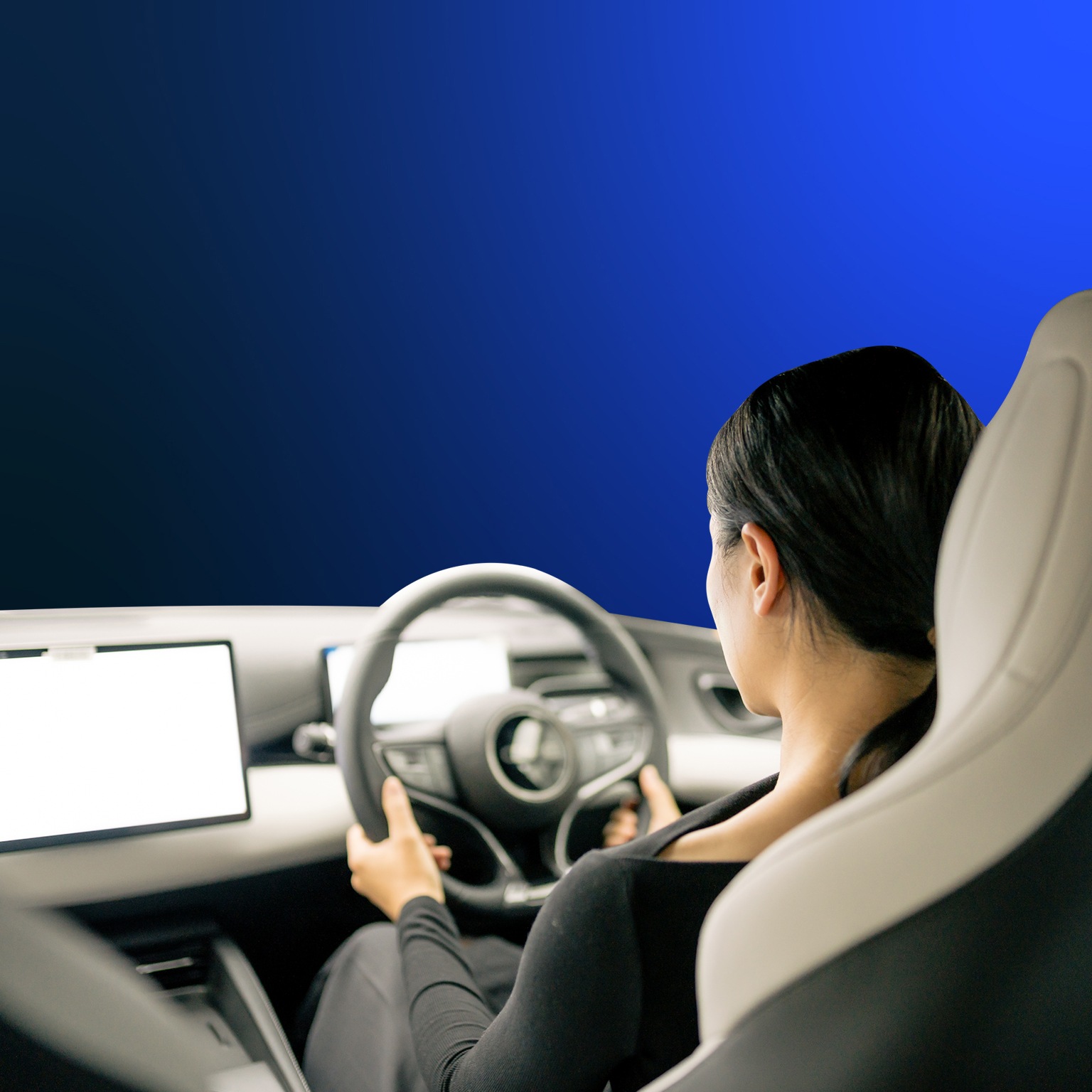 An Asian woman sits in the cockpit of a new energy car, operating a display with intelligent driving functions