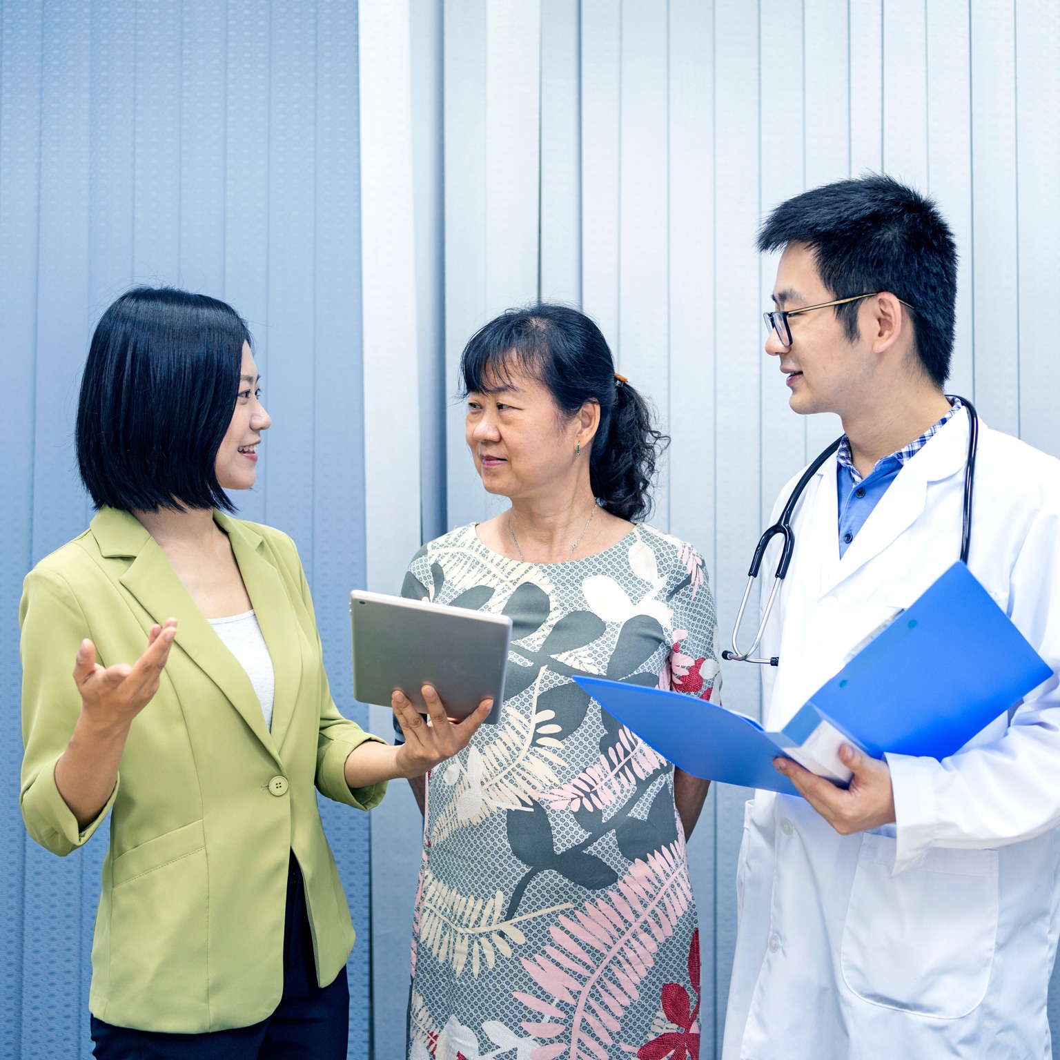 Asian care manager assisting her customer in communicating with doctor
