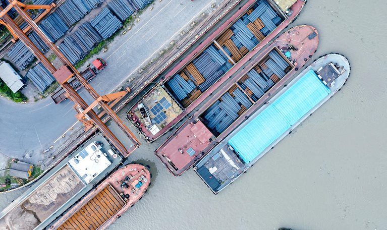 Aerial view of cargo ships docked at a steel terminal