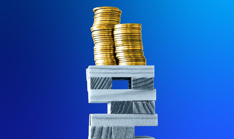Stacks of gold coins rest on top of a precarious tower made of wooden rectangular blocks against a deep blue background.