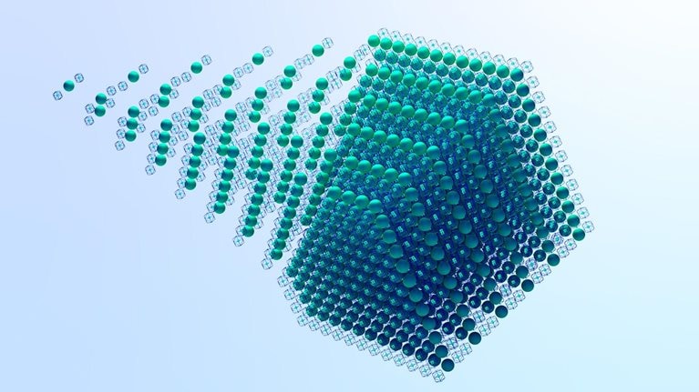 A visually striking image of a cube made of green spheres within wireframe boxes, with a sense of movement as the spheres seem to be trailing off from the main cube.