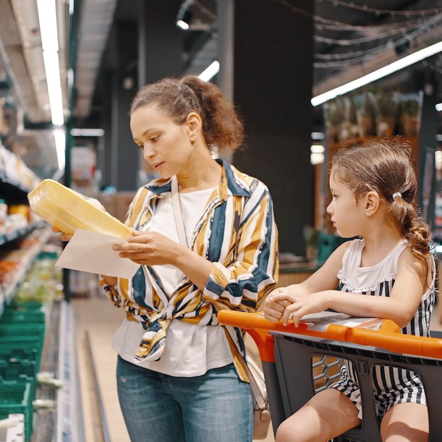 photo oh mom at grocery store with child sitting in shopping cart