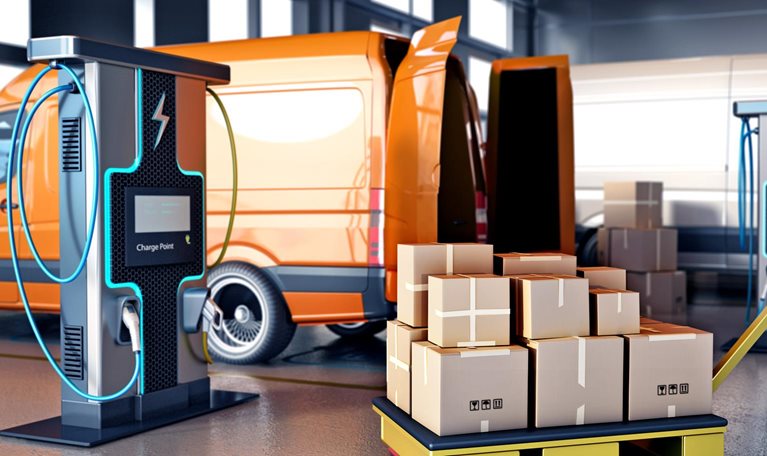 Packaged goods in cartons on trolleys next to transport vans