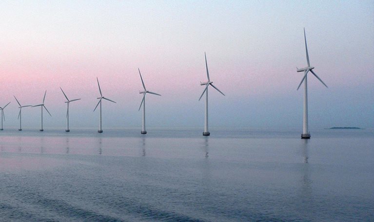 Wind farm at sunset in sea