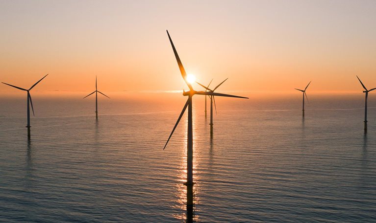 Offshore wind turbines at sunrise seen from an aerial point of view, Redcar, England, United Kingdom - stock photo