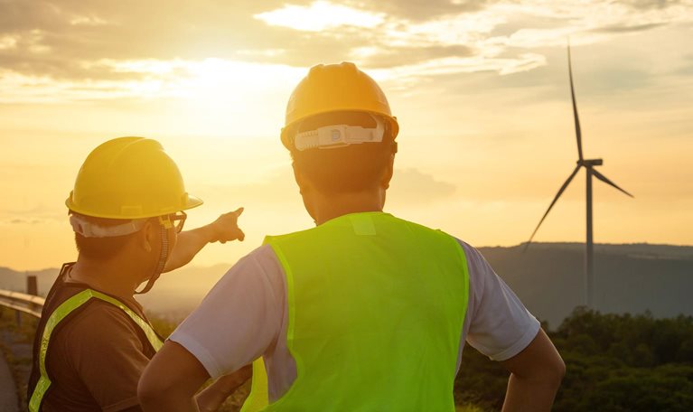 Two engineers discussed the plan for the maintenance of wind turbines and checking wind direction.