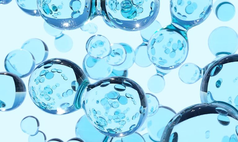 Digital generated image of transparent blue hydrogen atoms against white background.