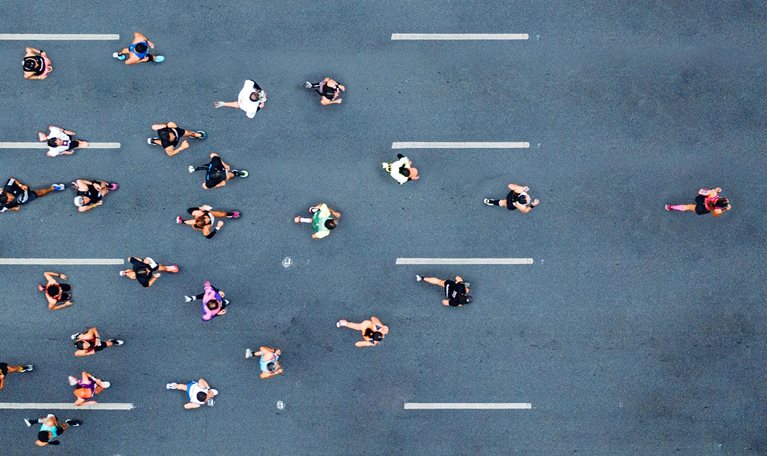 Aerial shot of marathon runners, with one runner leading the pack