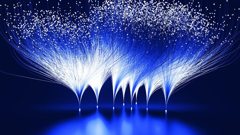 Abstract blue and white lines emanating from white dots against a dark blue background. This visual metaphor represents the branching-out and expansive growth facilitated by innovation.