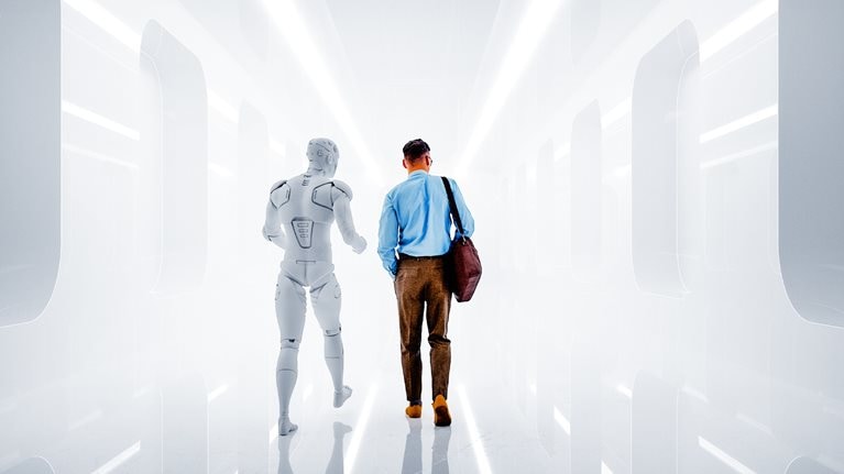 A man dressed in business-casual attire walks side by side with a humanoid robot down a futuristic corridor. The pair are viewed from behind, walking away from the viewer into the brightly lit space.